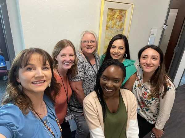 Six women of various ages, races, and nationalities are posing for a selfie.