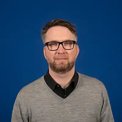 A middle-aged white man with graying short hair and a beard.